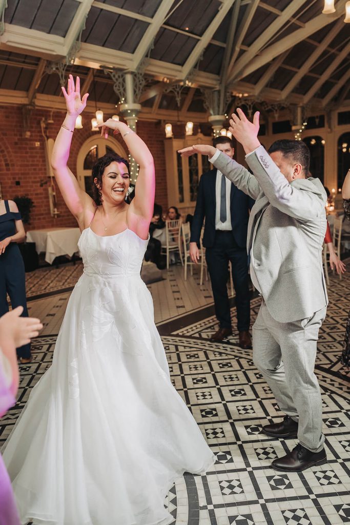 bride dancing in a Spanish style with arms in the air