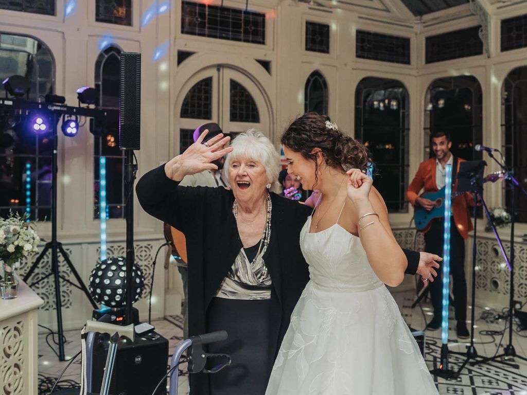 bride dancing and laughing with grandma on dancefloor