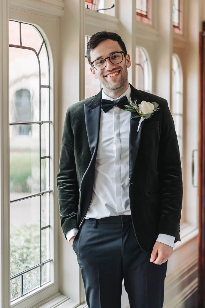 groom portrait of groom in green velvet tuxedo