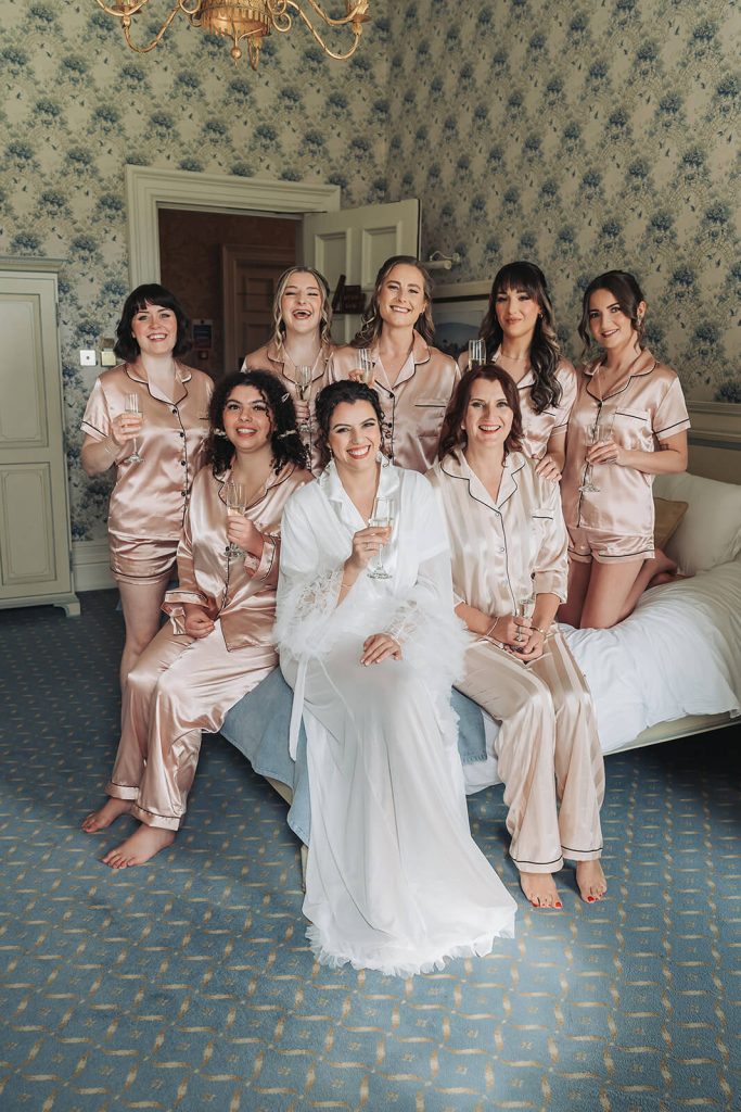 bridal party in pyjamas on bed
