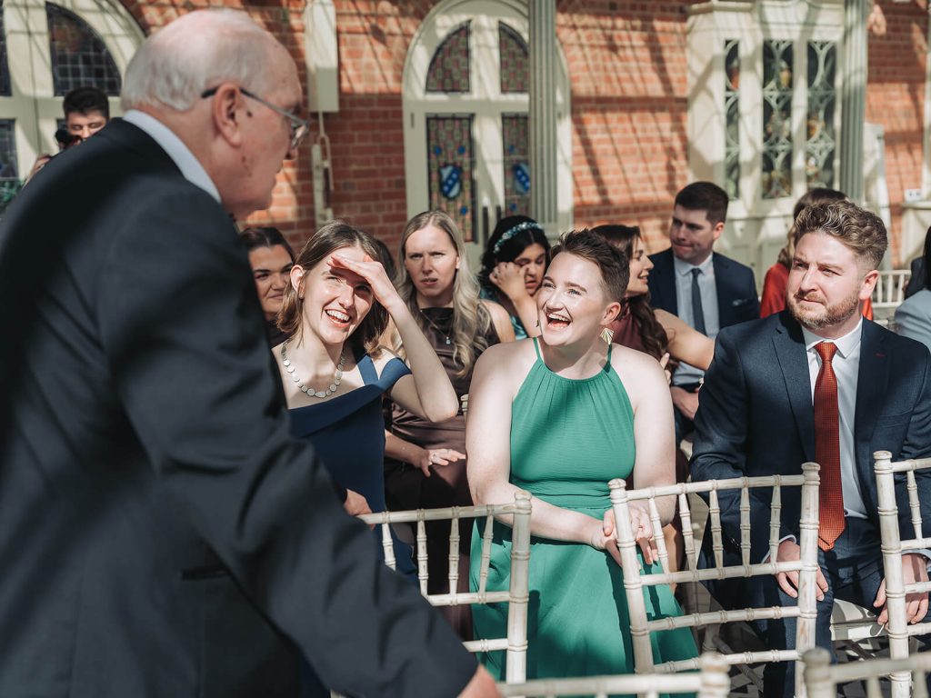 candid photo of wedding guests laughing