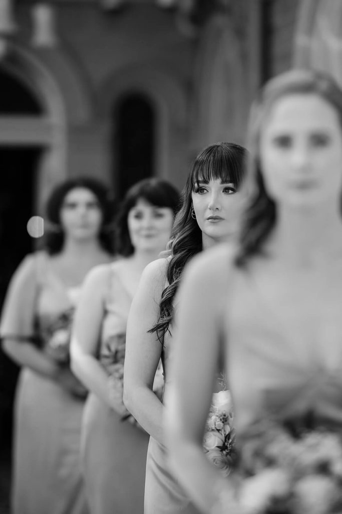 black and white photo of bridesmaids walking in