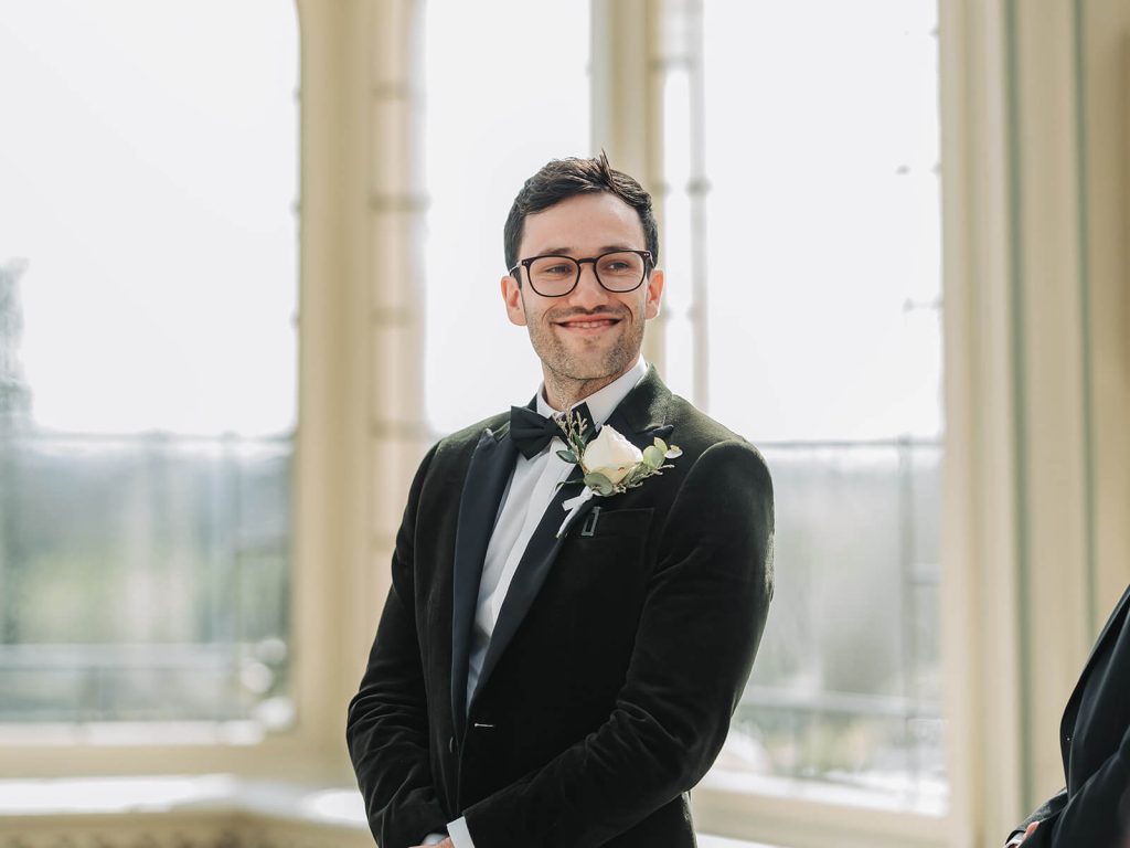 groom smiling looking back