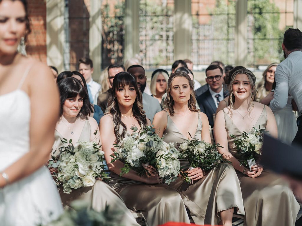 bridesmaids sat in wedding ceremony at Kilworth House