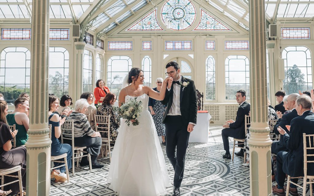 groom kissing bride's hand