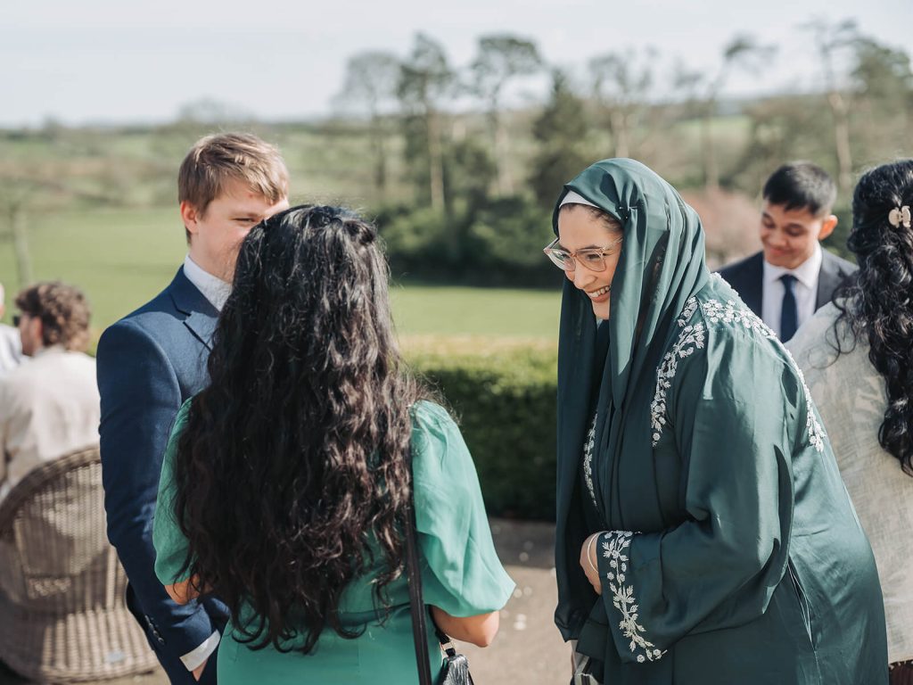 wedding guests laughing and talking