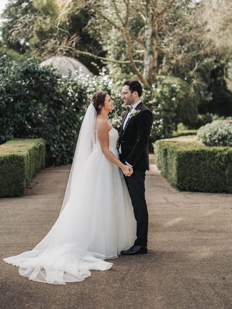 wedding couple holding hands and looking at eachother at Kilworth House wedding