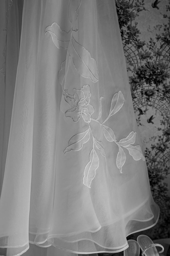 black and white photo of floral detail on wedding dress