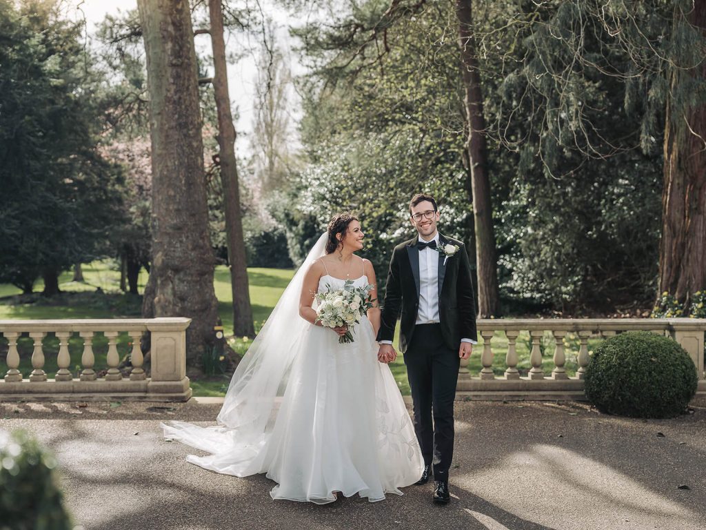 bride and groom holding hands walking at Kilworth House
