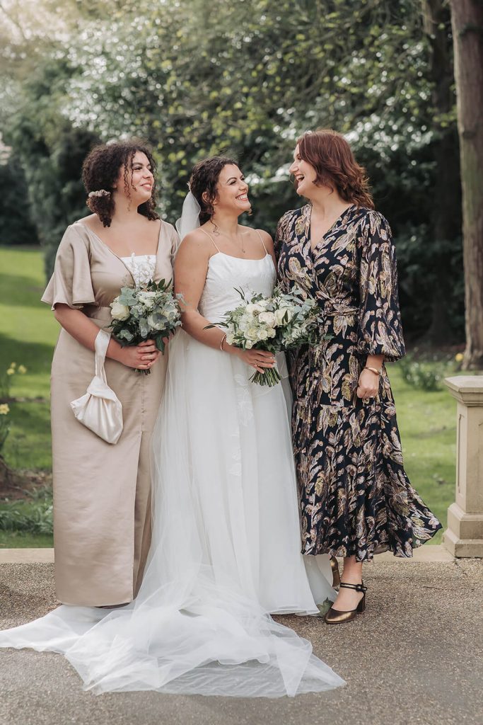 bride laughing with mum and sister