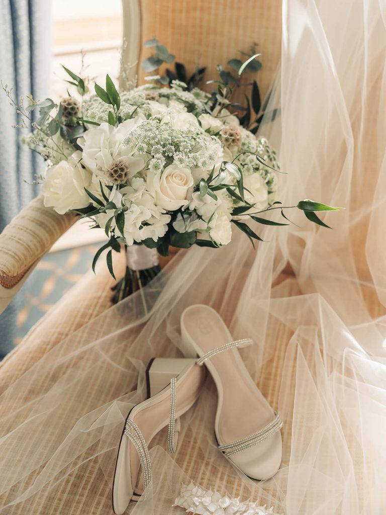 wedding shoes and white wedding bouquet with roses