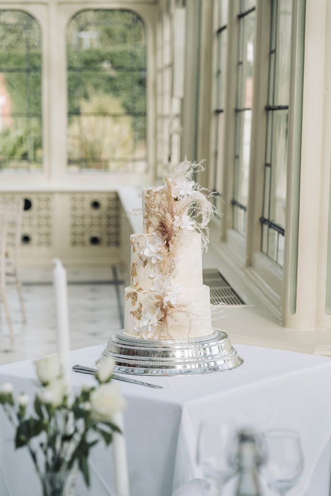 white wedding cake with feathers