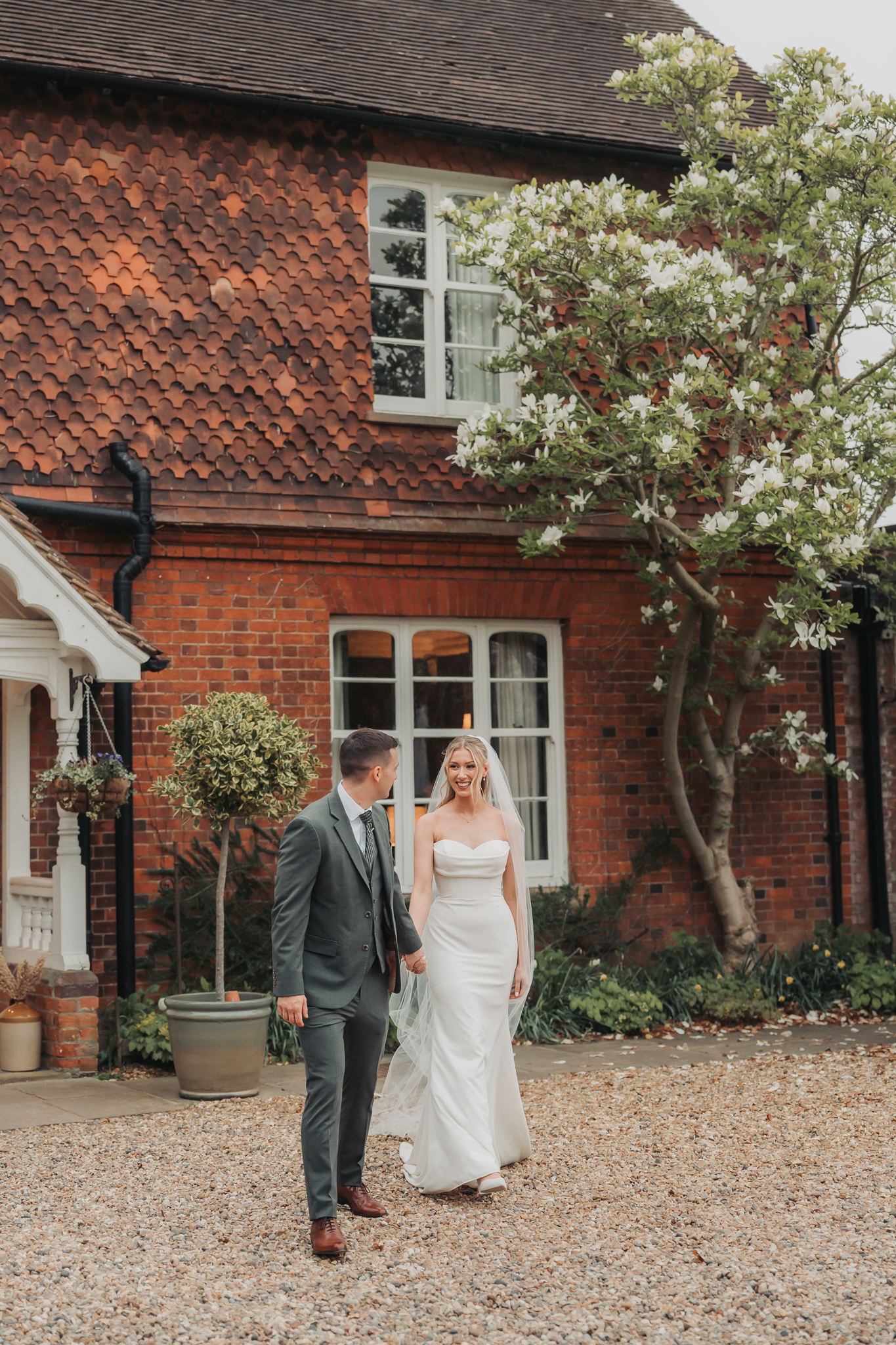 bride and groom outside farmhouse at Redcoats