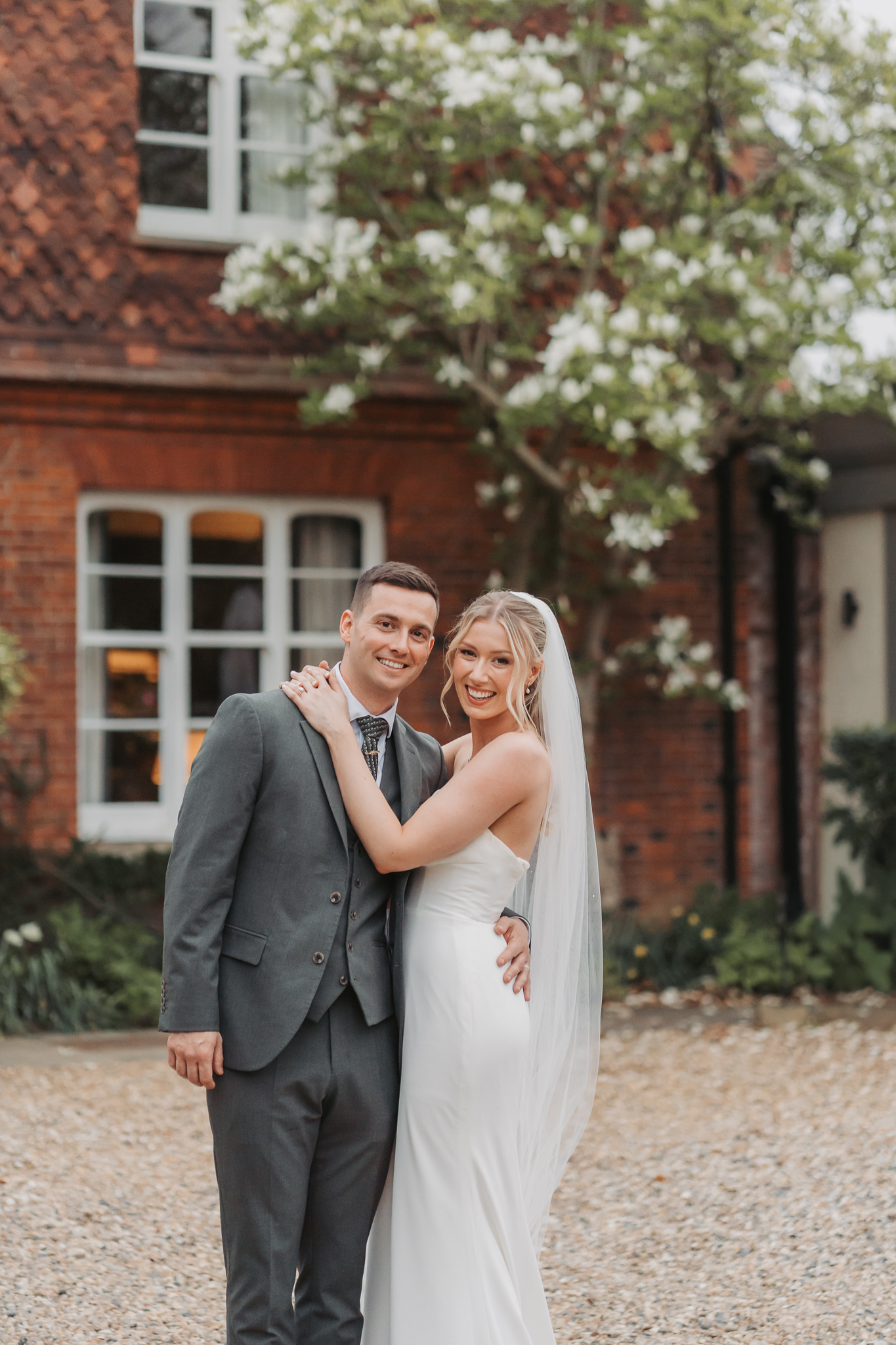 bride and groom smiling at the camera at Farmhouse at Redcoats Hitchin