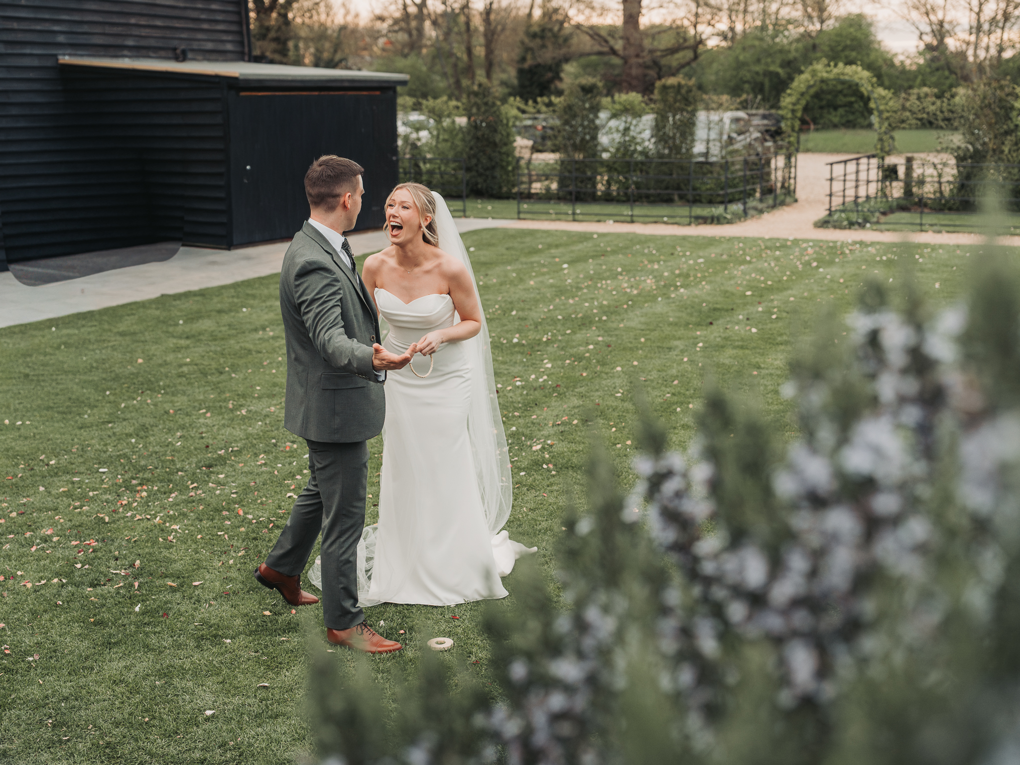 bride and groom laughing playing garden games