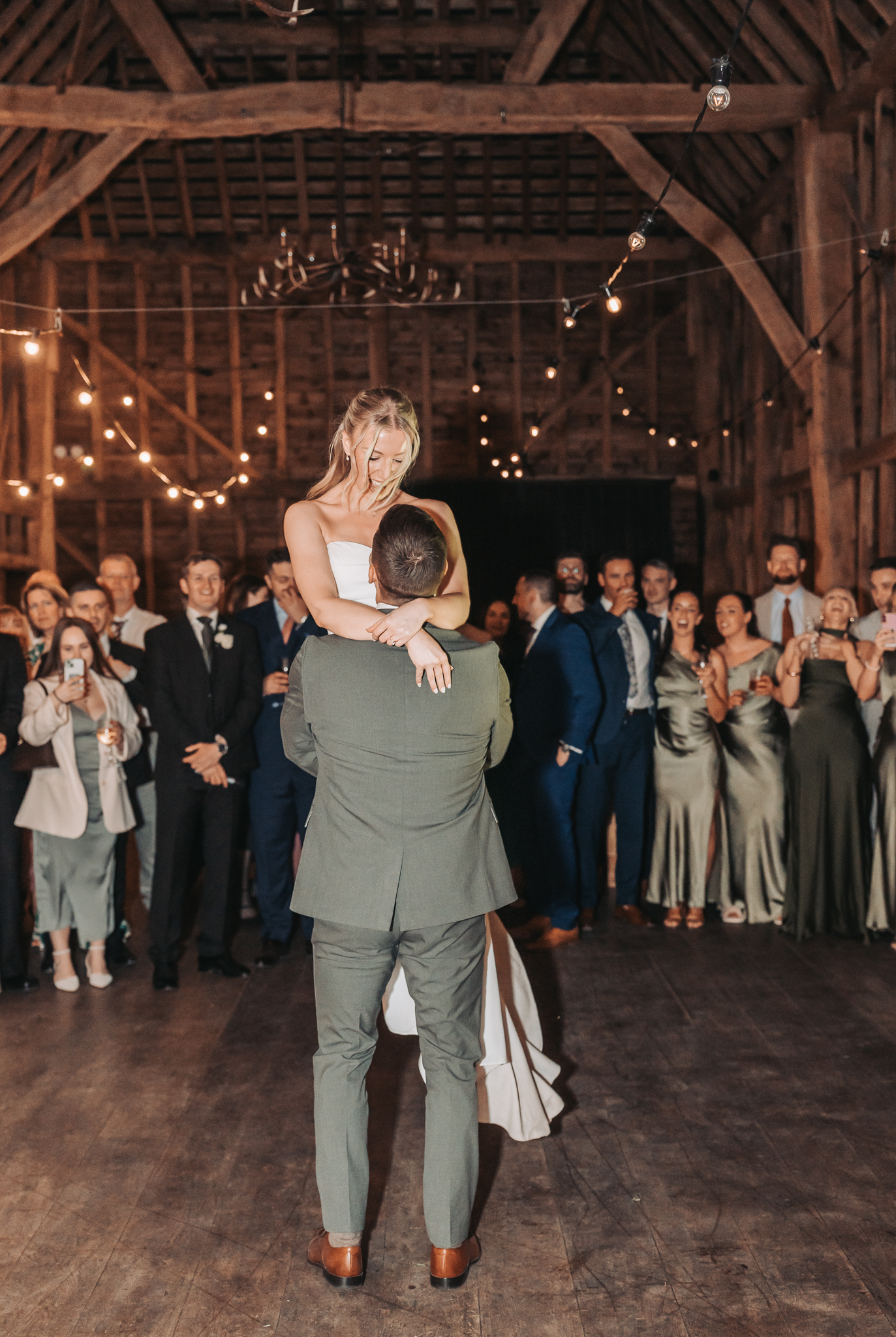 groom lifting bride on dancefloor