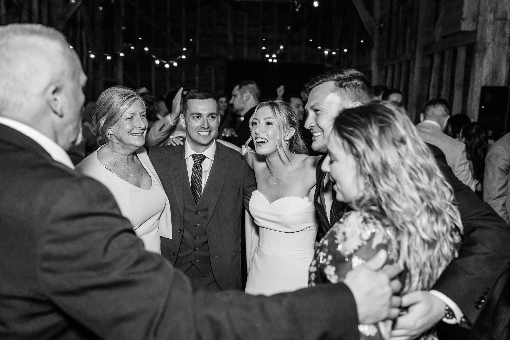 black and white photo of family cuddling on dancefloor