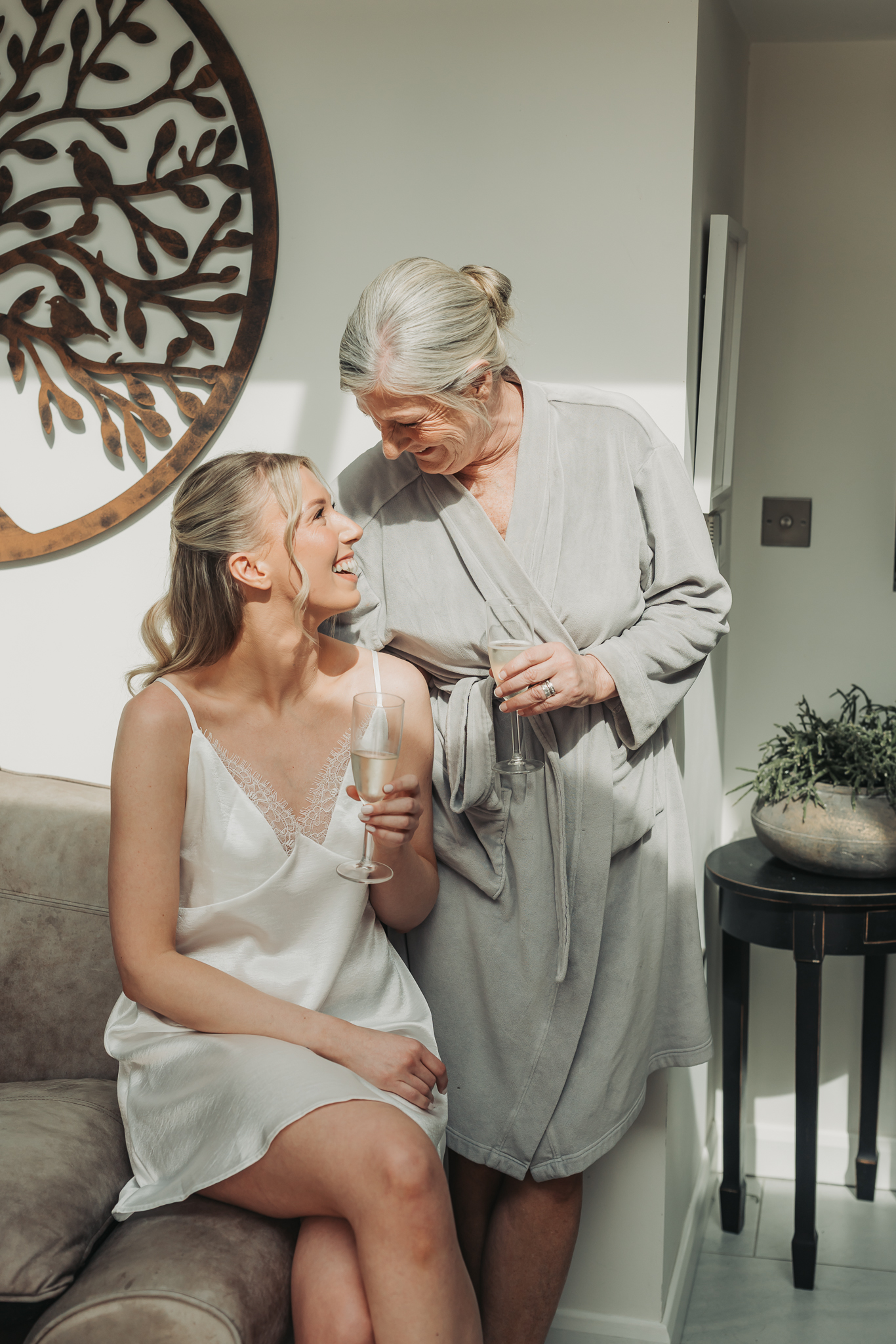 mum and daughter laughing together at bridal prep in Hitchin