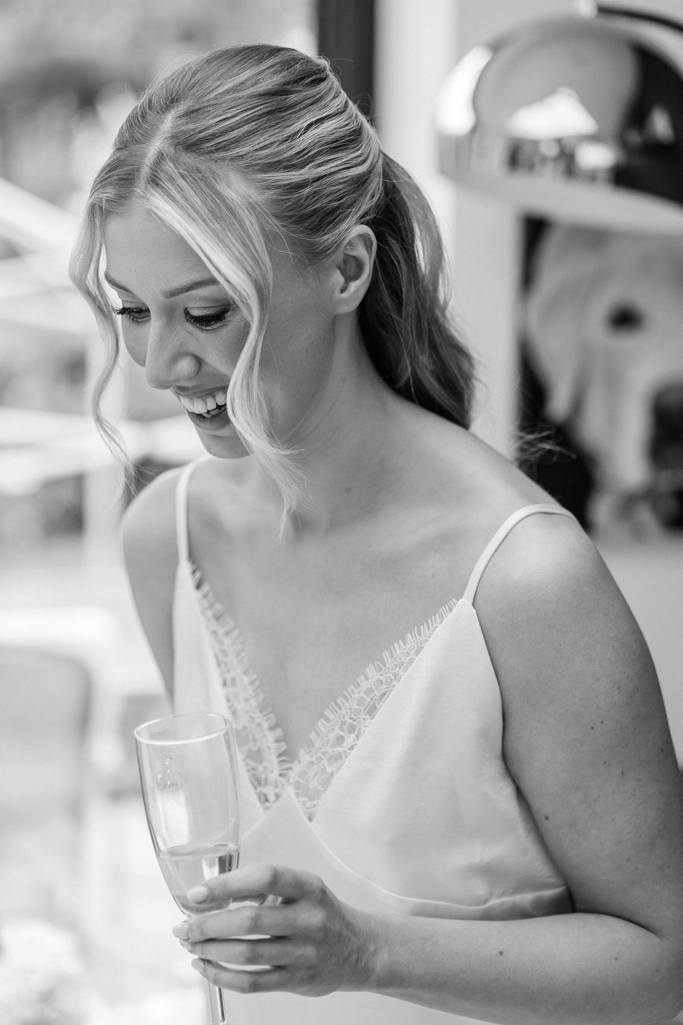 black and white photo of bride looking down and laughing