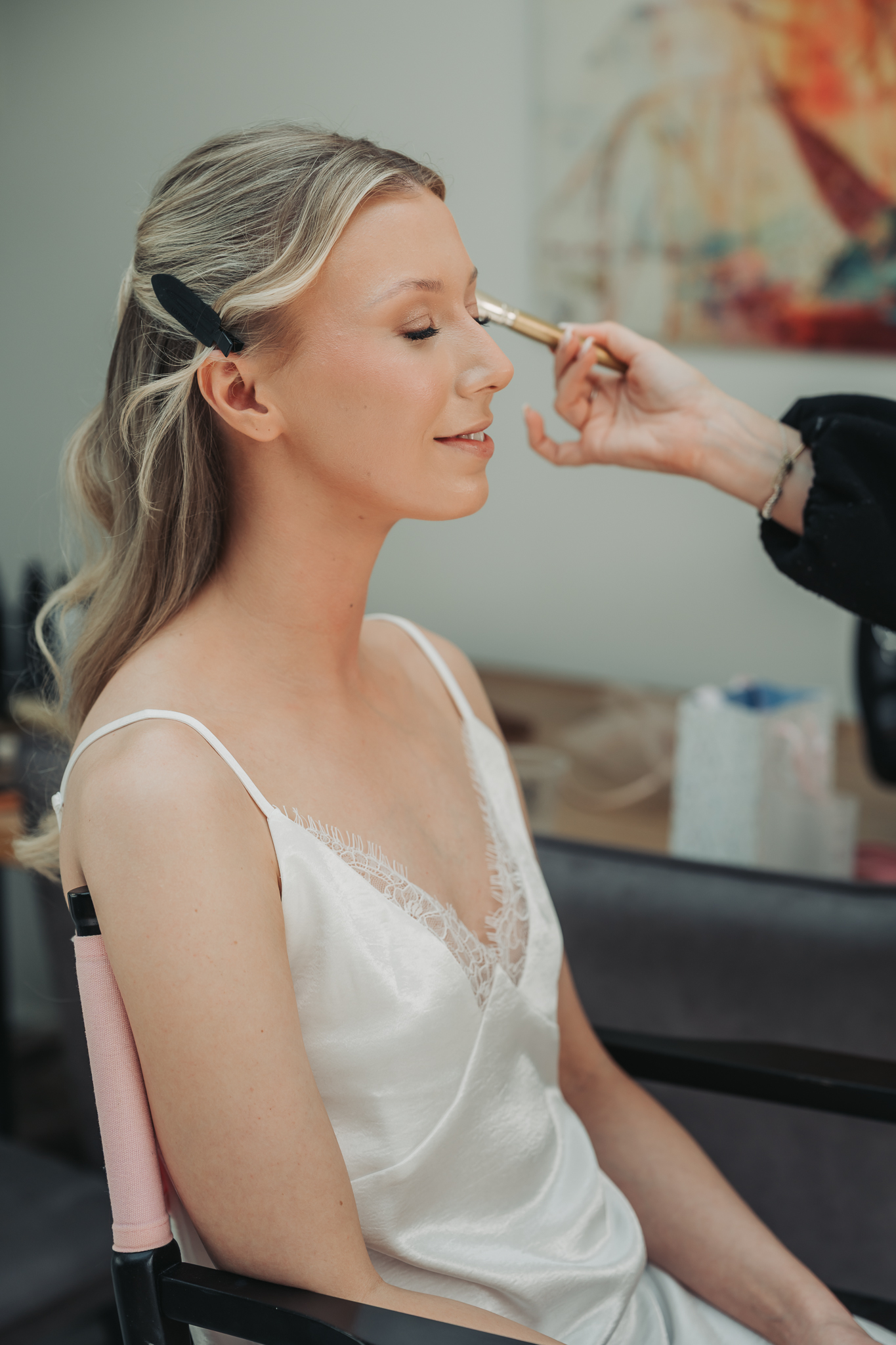 Blonde haired bride having make-up done