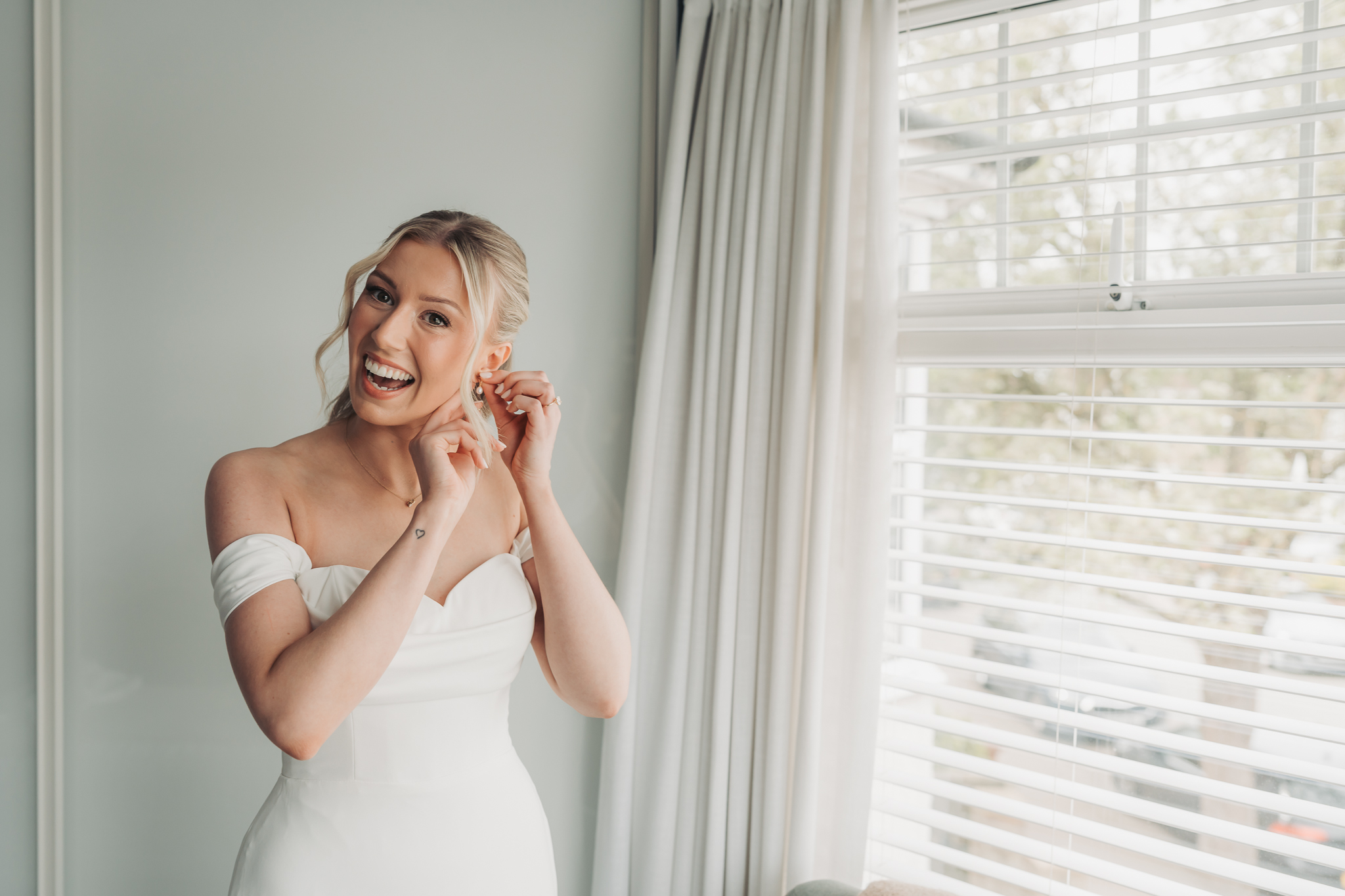 bride putting earring on