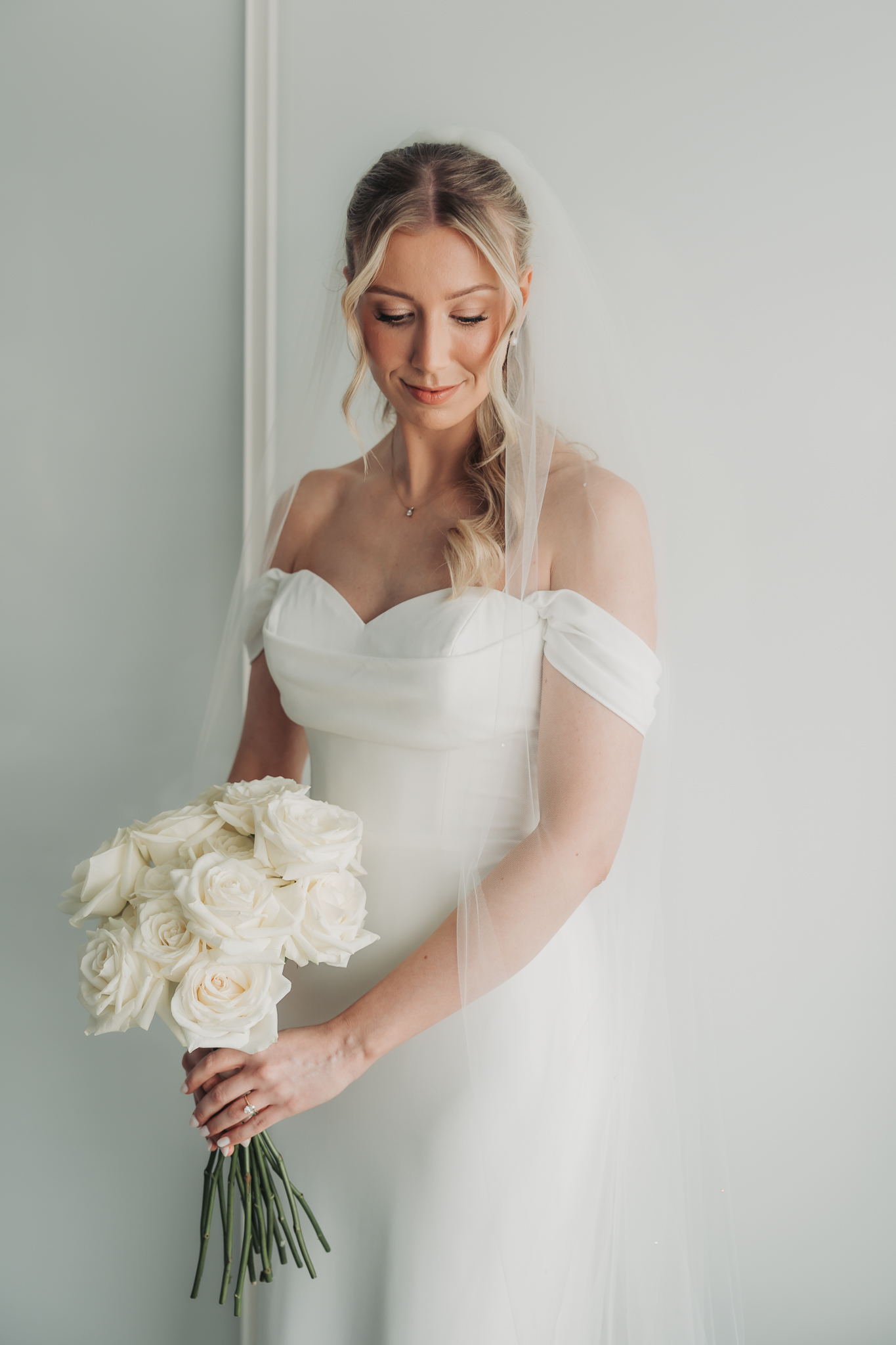 bride glancing down holding bouqet