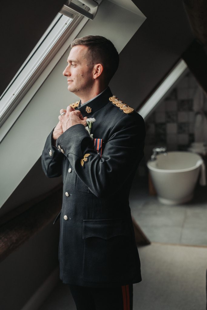 groom in formal military uniform getting ready