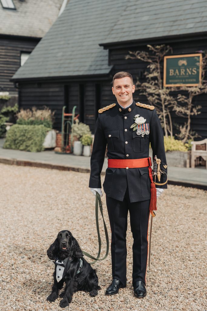 groom in military uniform and dog