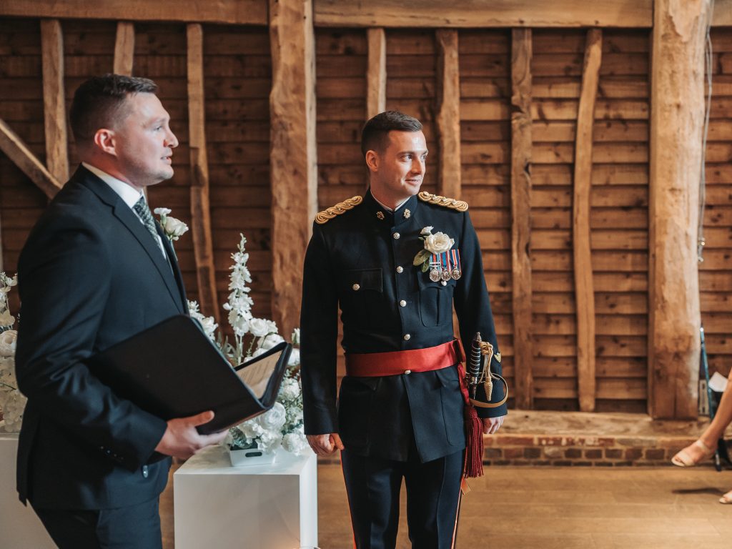 groom waiting at top of aisle
