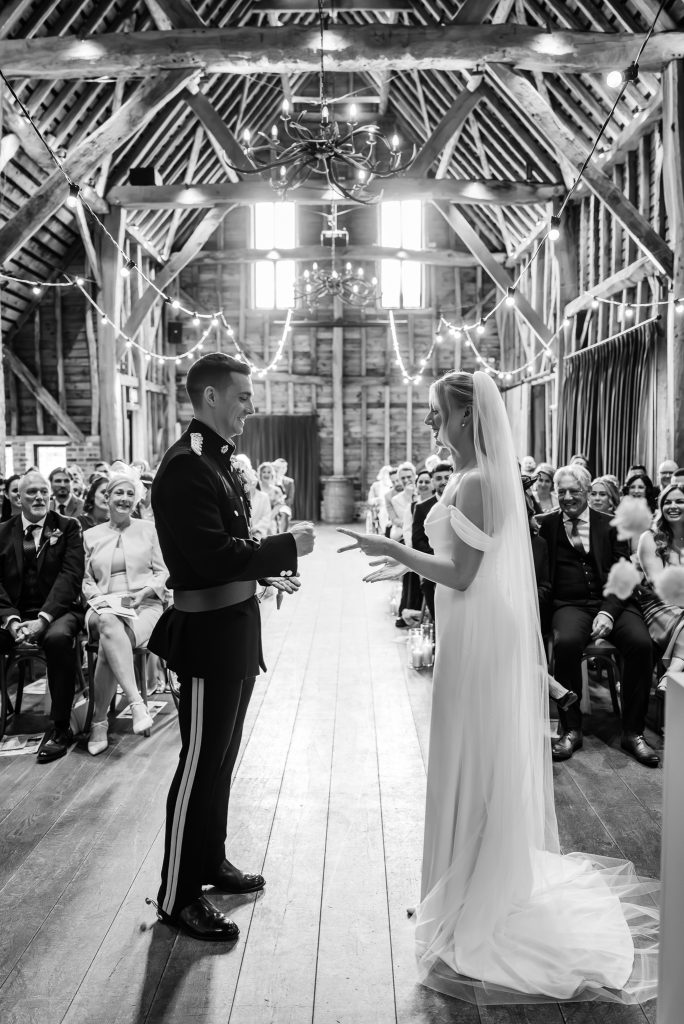 black and white photo of bride and groom playing rock paper scissors