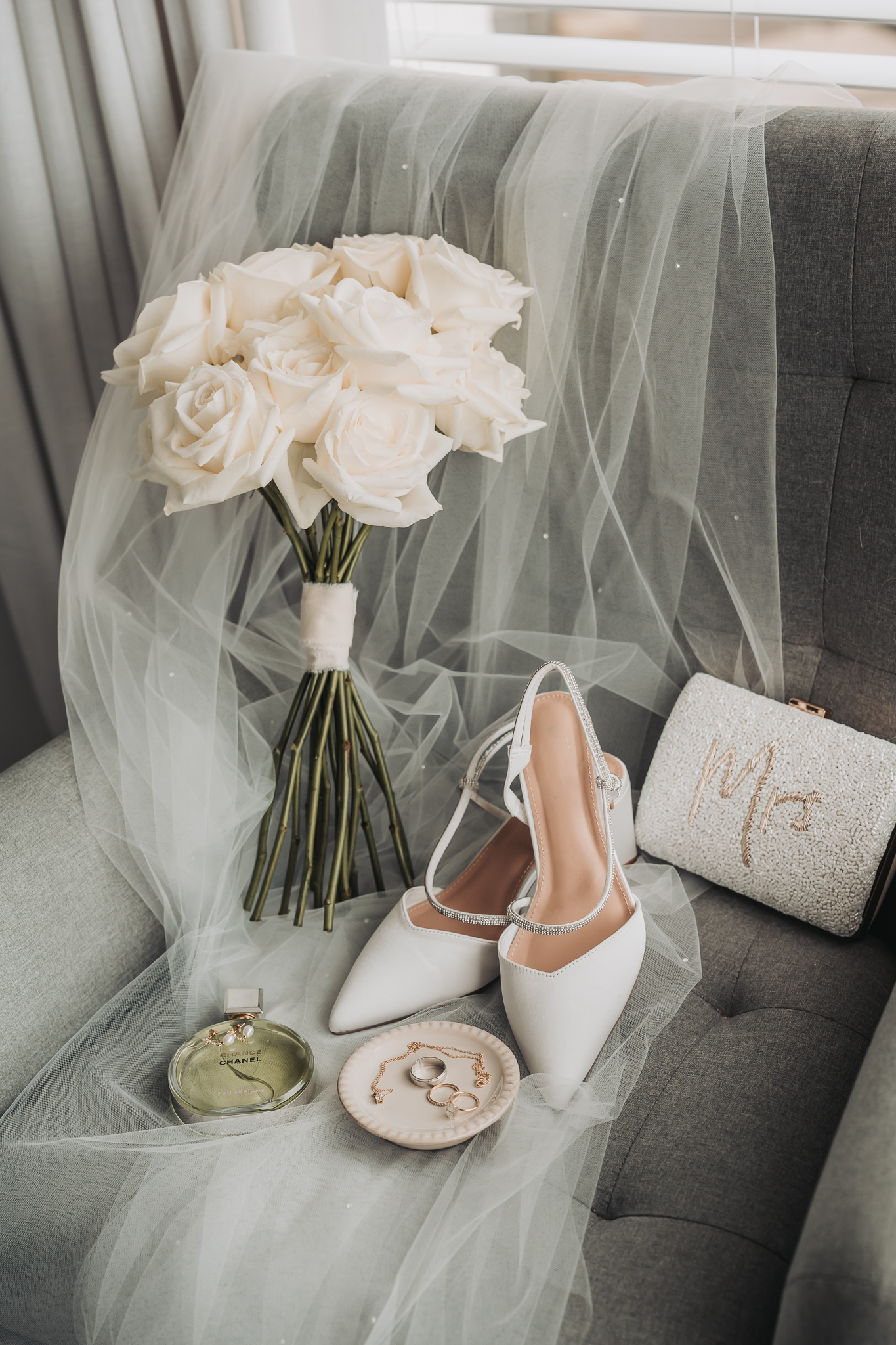 Bridal details including shoes and white rose bouquet