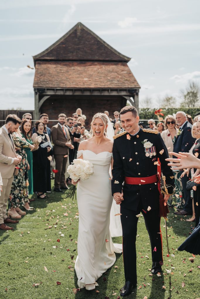 bride and groom walking through confetti