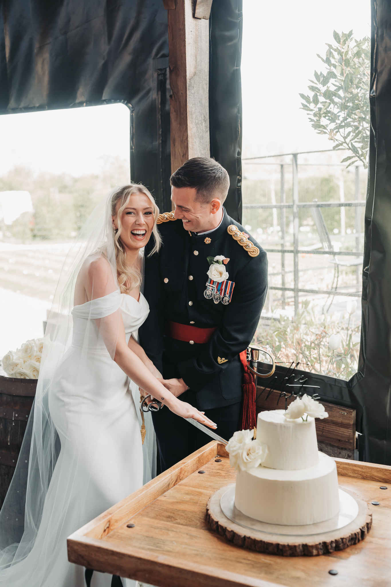 bride and groom cutting cake with sword