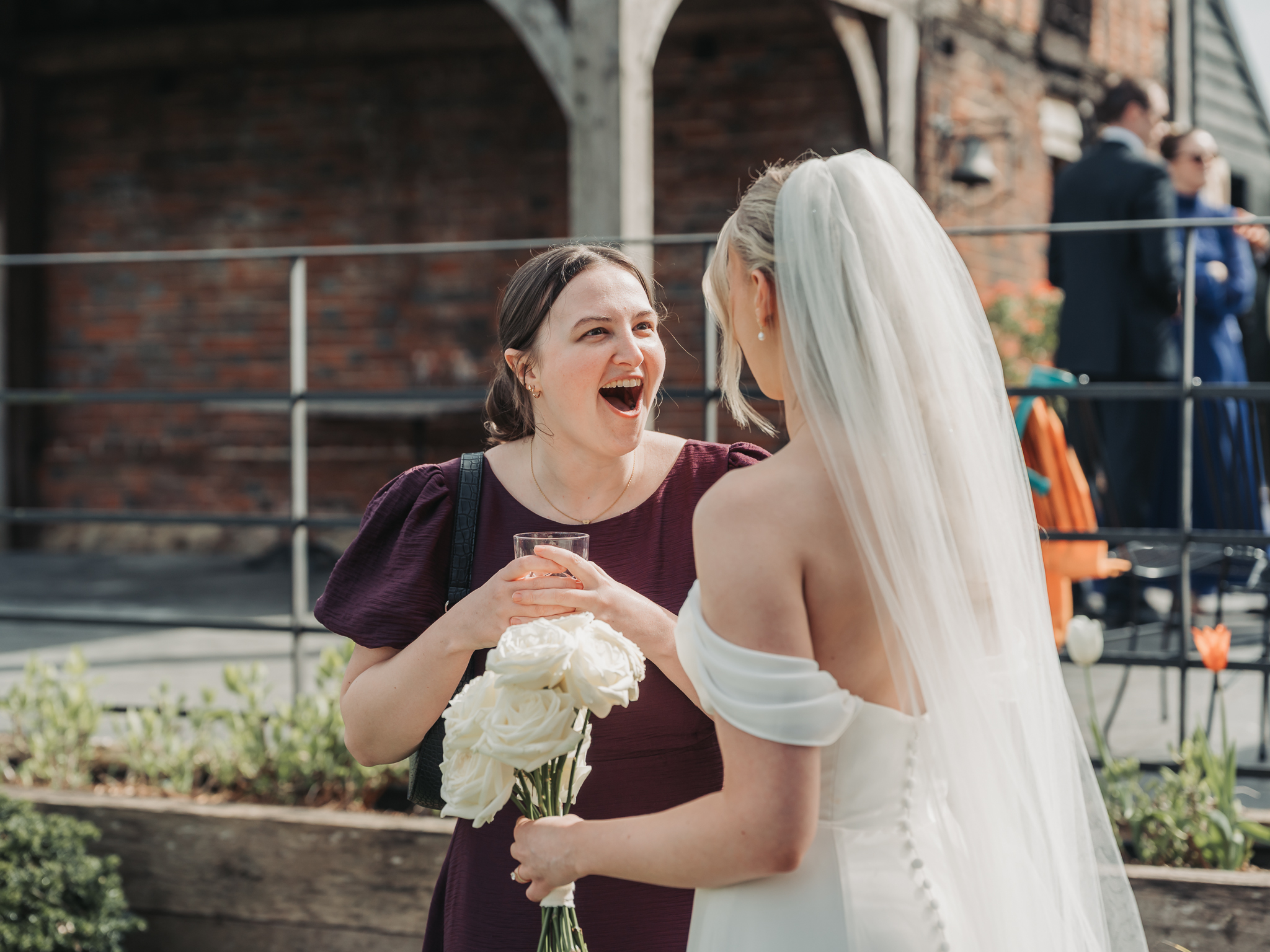 wedding guest laughing with bride