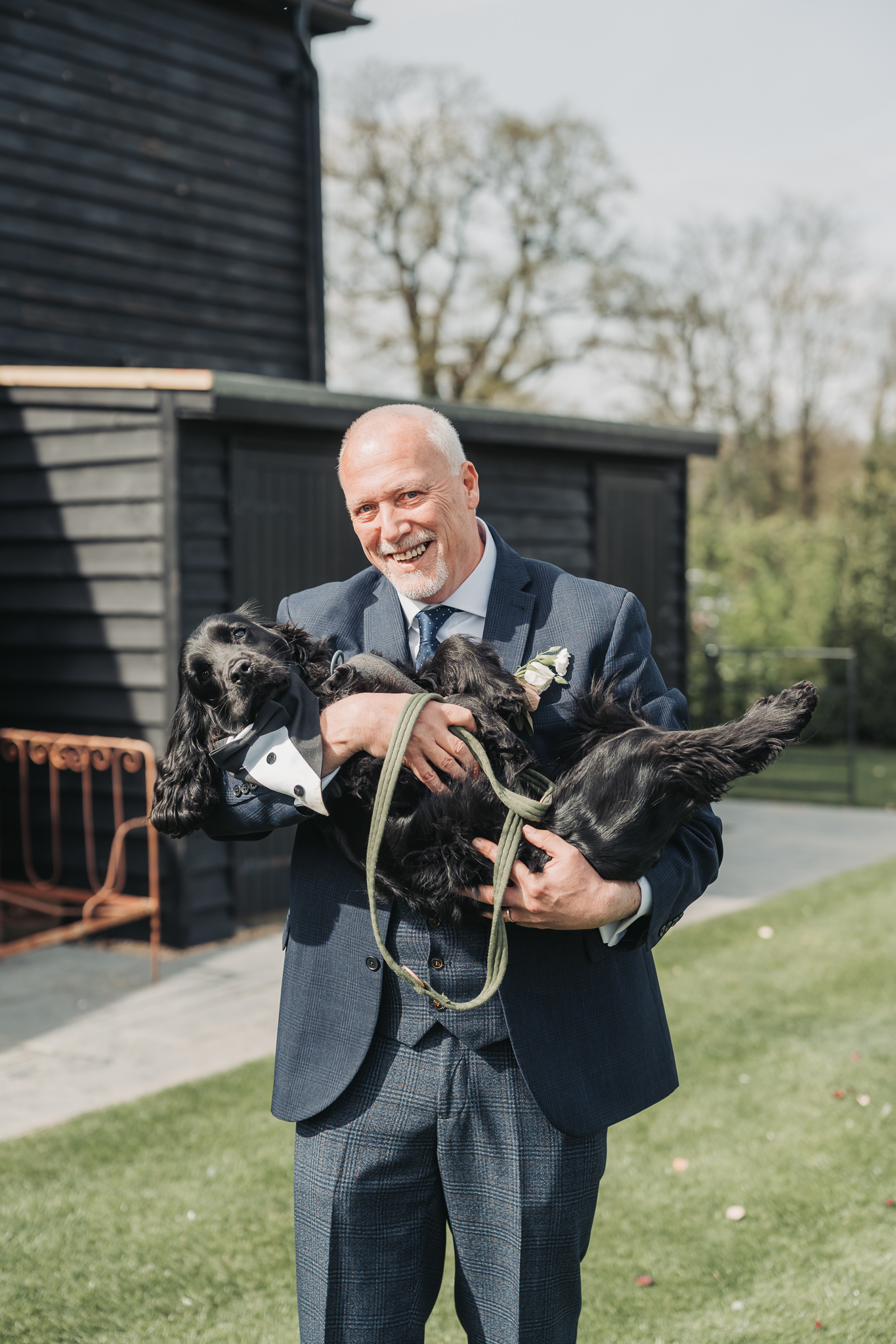 dad holding dog like a baby