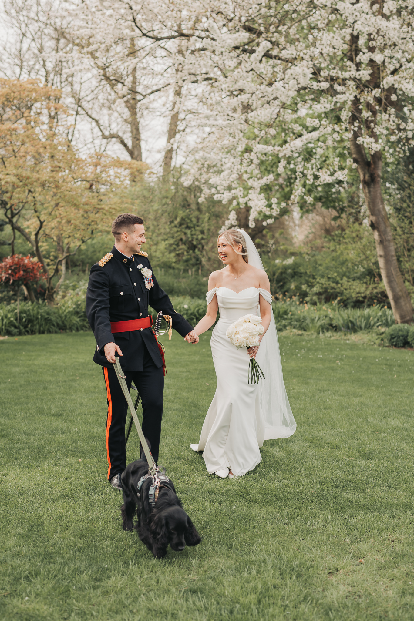 bride and groom walking with dog