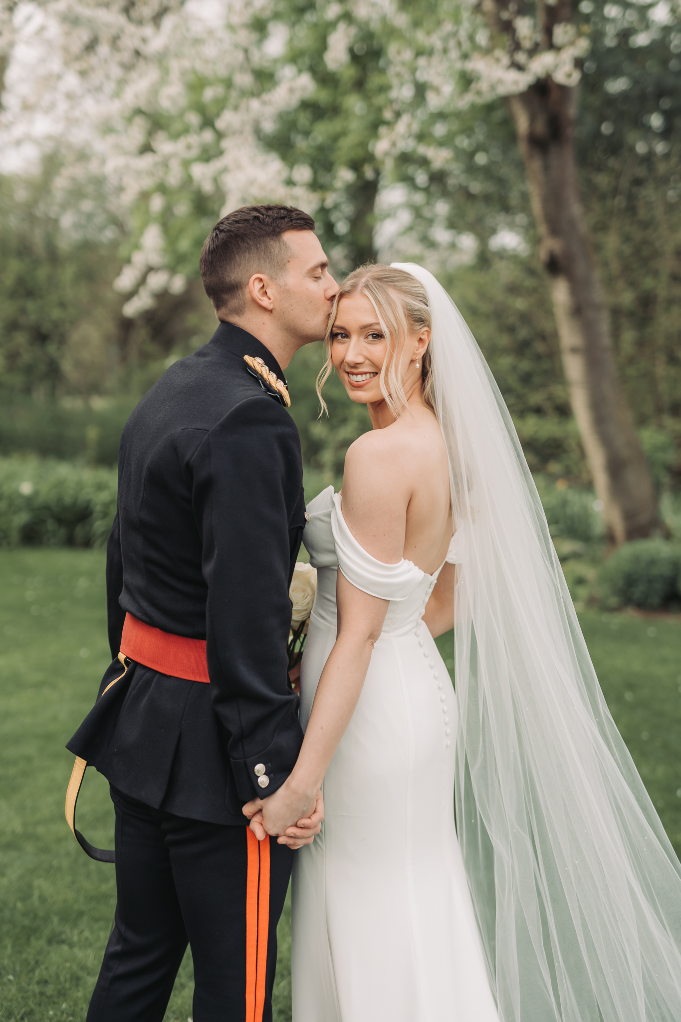 groom kissing brides forehead