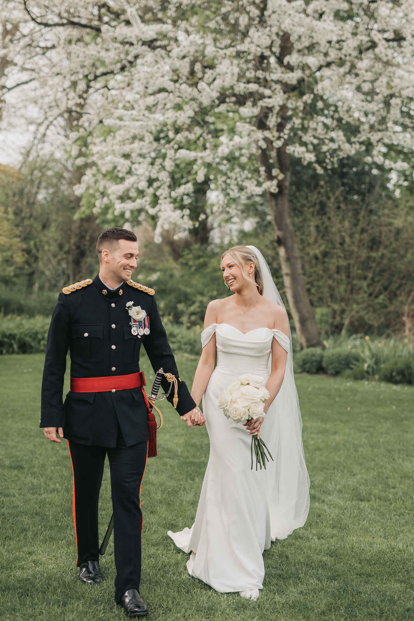 wedding couple holding hands smiling at Redcoats Hitchin