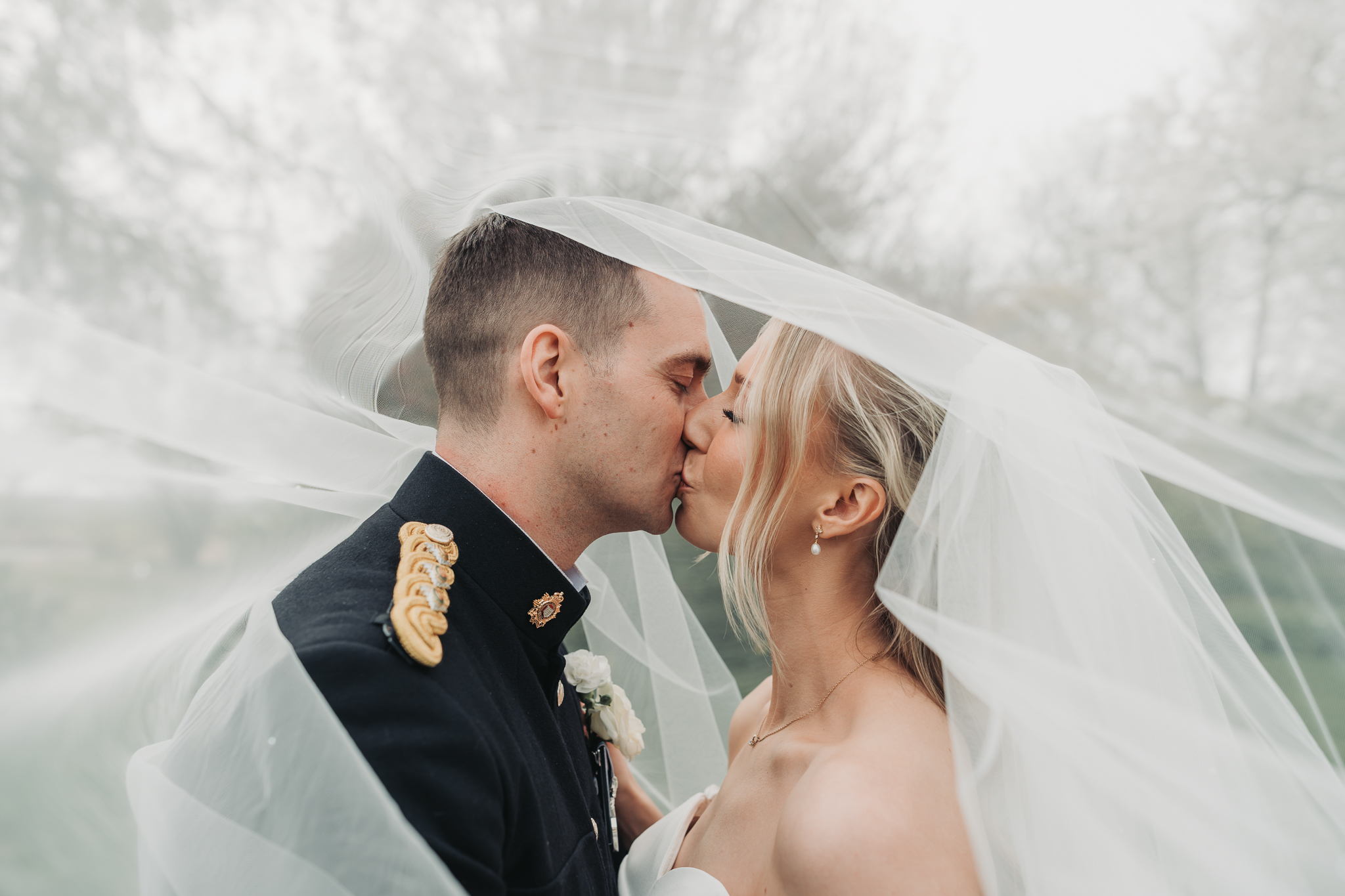 couple kissing under veil