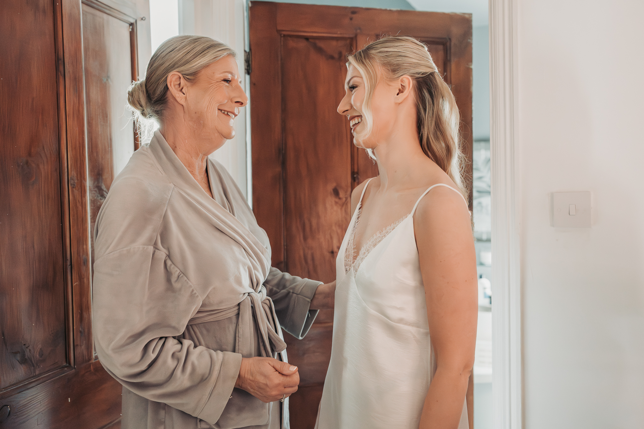 bride and mum smiling at eachother at bridal prep in Hitchin